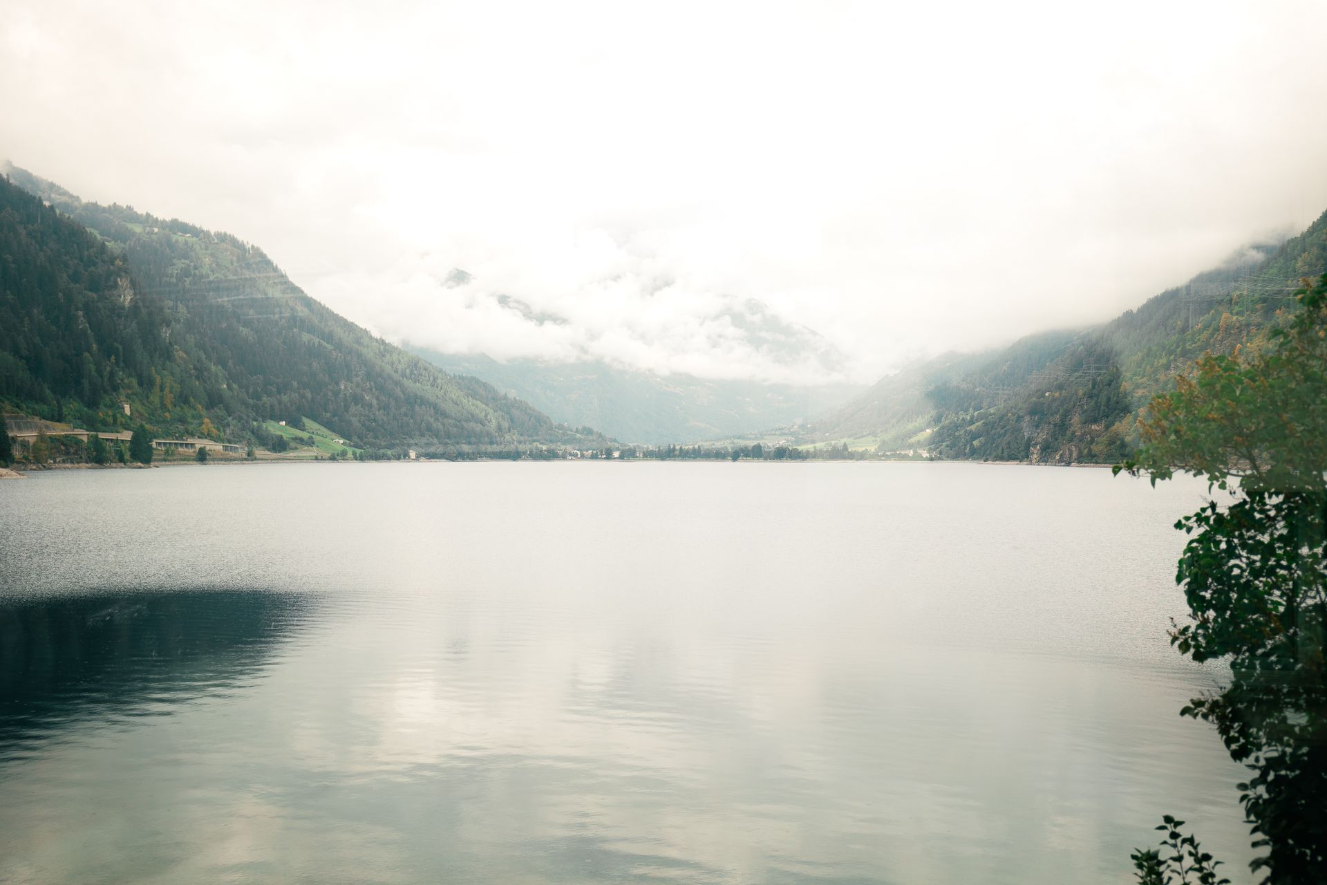 St Moritz lake and mountains on a misty summer morning